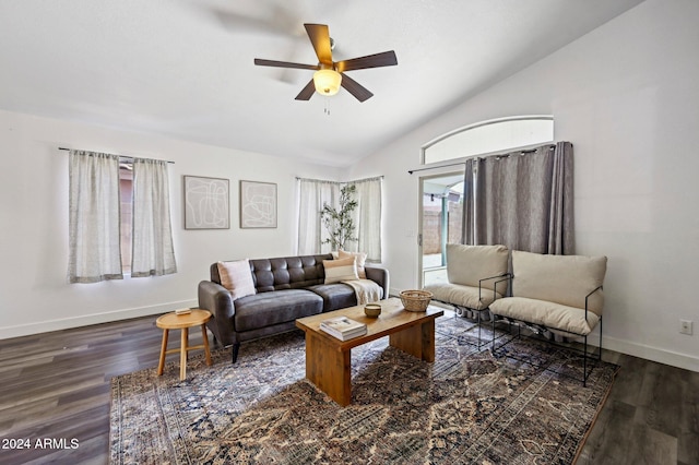 living room featuring dark wood-type flooring, a healthy amount of sunlight, and lofted ceiling