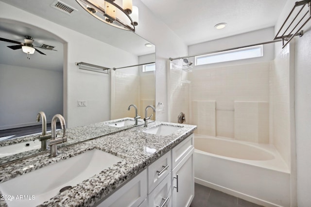 bathroom with ceiling fan, tile patterned flooring, vanity, and tiled shower / bath combo