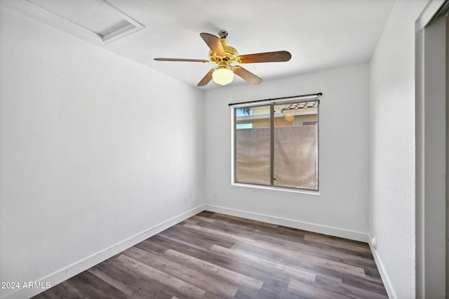 empty room with ceiling fan and dark wood-type flooring