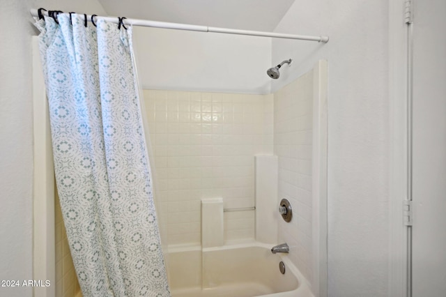 bathroom with shower / bath combo with shower curtain