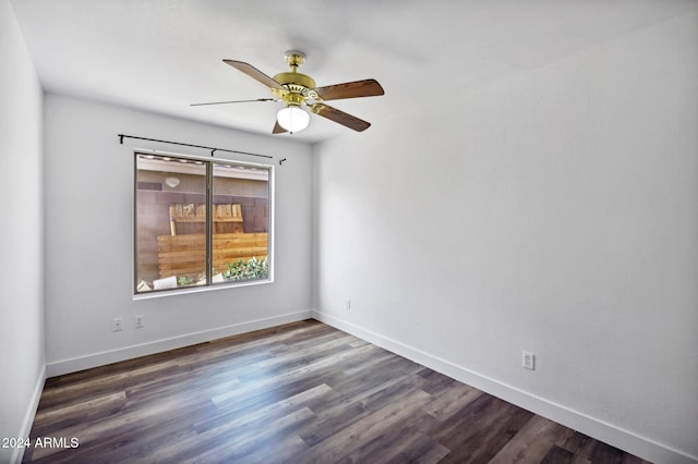 spare room featuring ceiling fan and dark hardwood / wood-style flooring