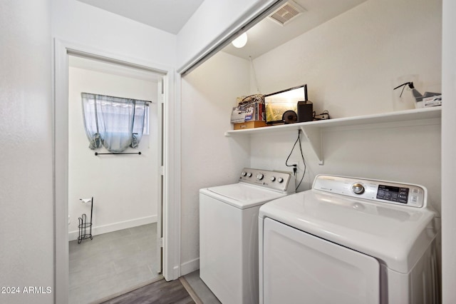 clothes washing area with washing machine and clothes dryer