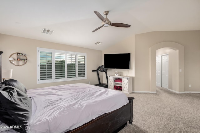 carpeted bedroom featuring a closet, vaulted ceiling, and ceiling fan