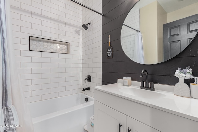 bathroom featuring vanity and shower / bathtub combination with curtain