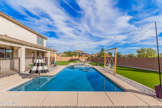 view of pool featuring a patio, an in ground hot tub, and a lawn