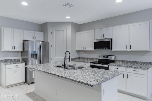 36257 W San Clemente Ave, Maricopa, AZ 85138 - kitchen with white cabinetry, stainless steel appliances, a sink, light stone counters, and visible vents