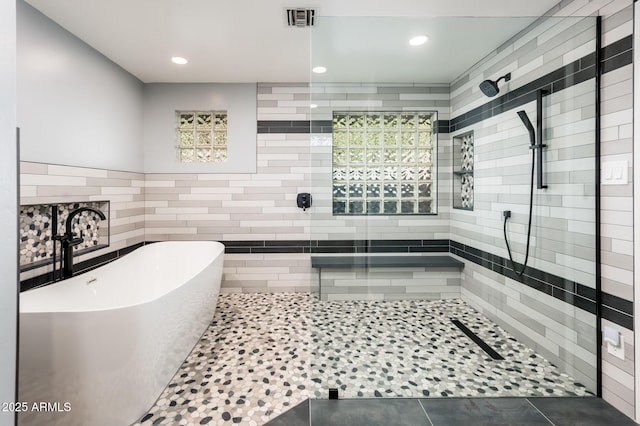 full bathroom with a soaking tub, visible vents, tiled shower, and recessed lighting