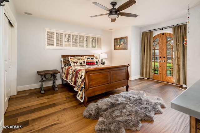 bedroom with access to exterior, french doors, baseboards, and wood finished floors