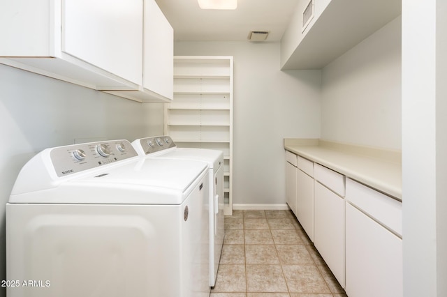 laundry room featuring visible vents, separate washer and dryer, light tile patterned floors, and cabinet space