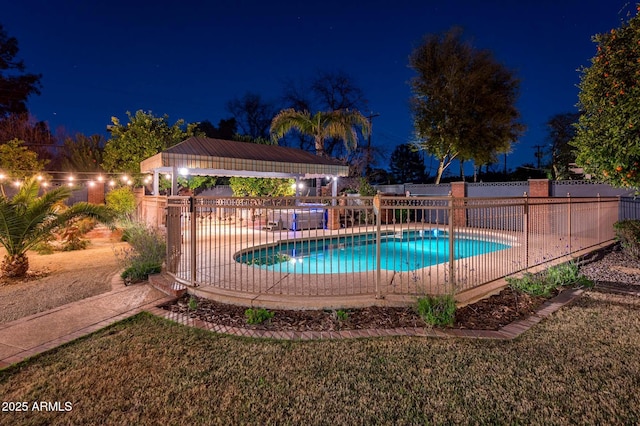 pool at twilight with fence and a fenced in pool