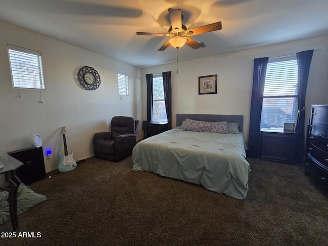 carpeted bedroom featuring multiple windows and ceiling fan