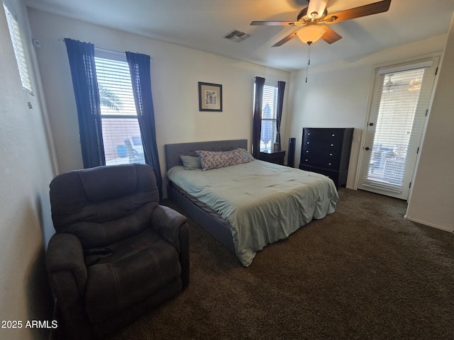 carpeted bedroom with multiple windows and ceiling fan