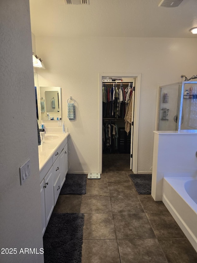 bathroom featuring vanity, tile patterned floors, and separate shower and tub