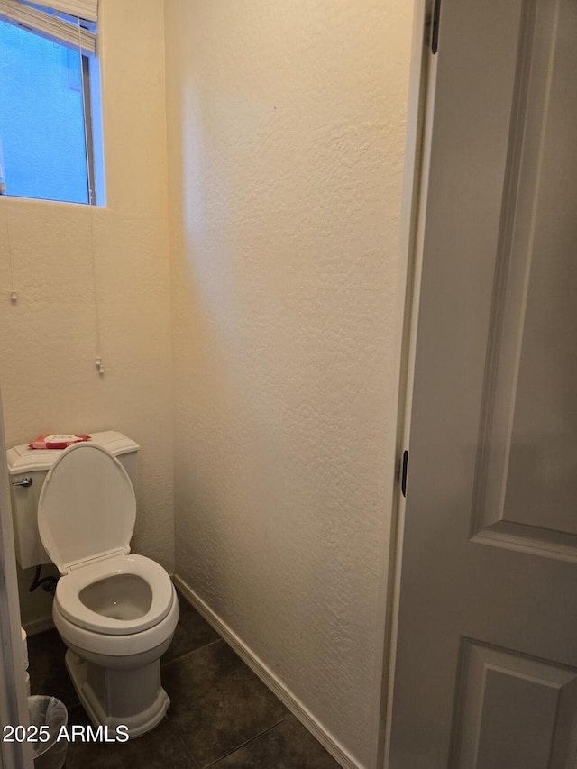 bathroom with tile patterned floors and toilet