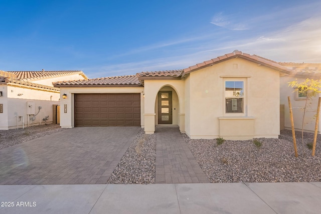 mediterranean / spanish-style house featuring a garage