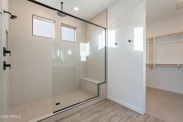 bathroom featuring wood-type flooring and tiled shower