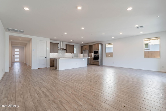 unfurnished living room featuring light wood-type flooring