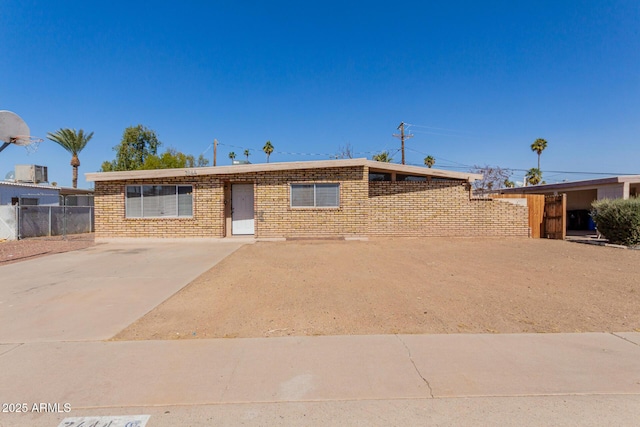 single story home with fence and brick siding