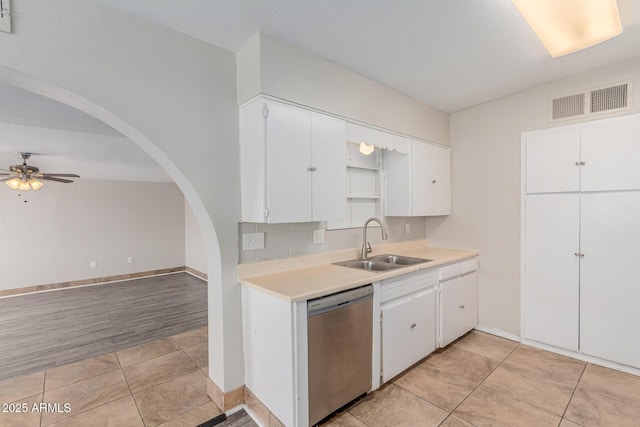 kitchen featuring a sink, visible vents, white cabinetry, light countertops, and dishwasher