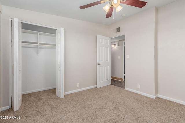 unfurnished bedroom featuring carpet, a closet, visible vents, and baseboards