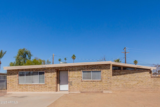 single story home featuring brick siding