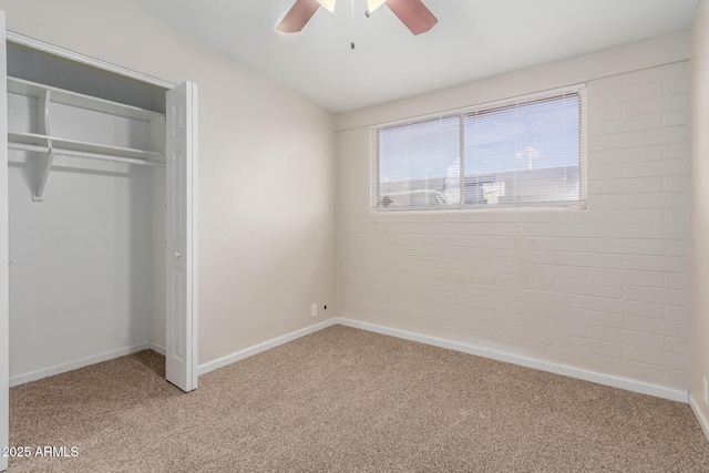 unfurnished bedroom featuring light carpet, ceiling fan, a closet, and baseboards