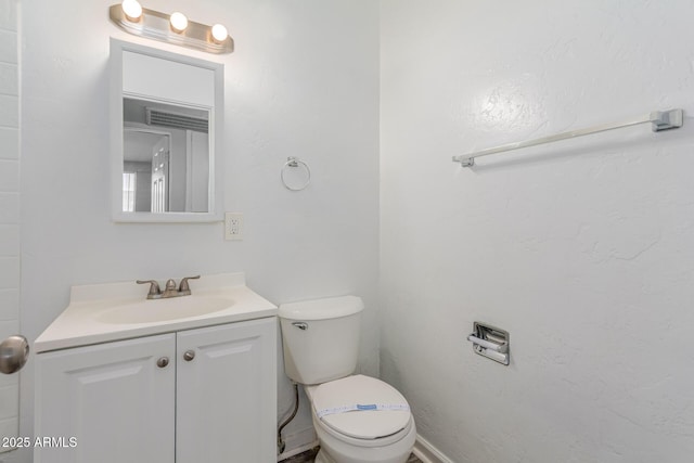 half bath with vanity and toilet