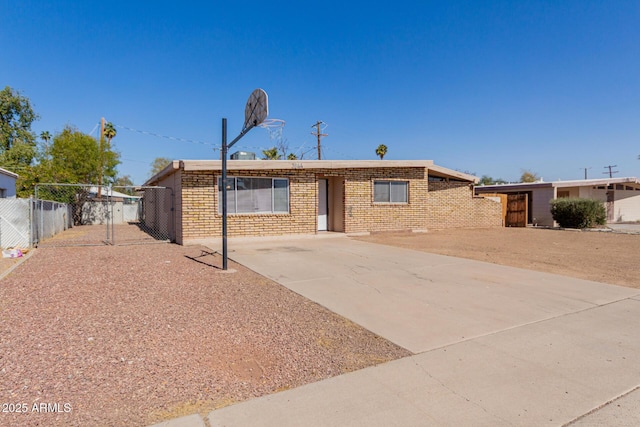 single story home featuring a gate, brick siding, and fence