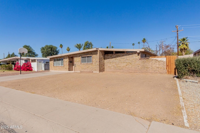 single story home with brick siding and fence