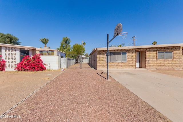 exterior space with fence and brick siding