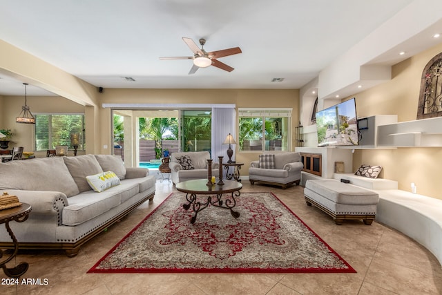 living room featuring ceiling fan and light tile patterned flooring