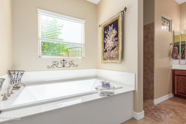 bathroom with vanity, tile patterned floors, and a bathtub