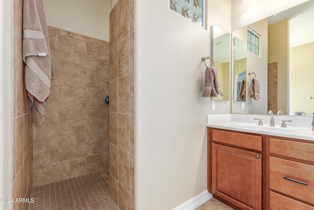 bathroom with vanity and tiled shower