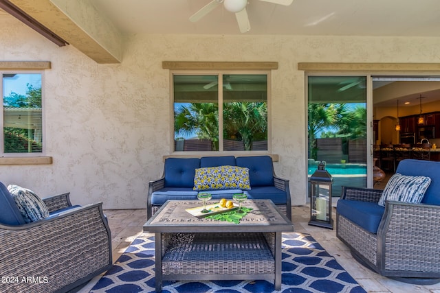 view of patio with an outdoor living space, sink, and ceiling fan