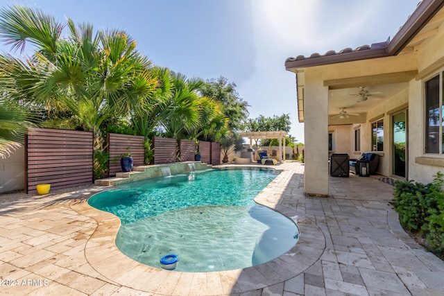 view of swimming pool featuring pool water feature, ceiling fan, and a patio