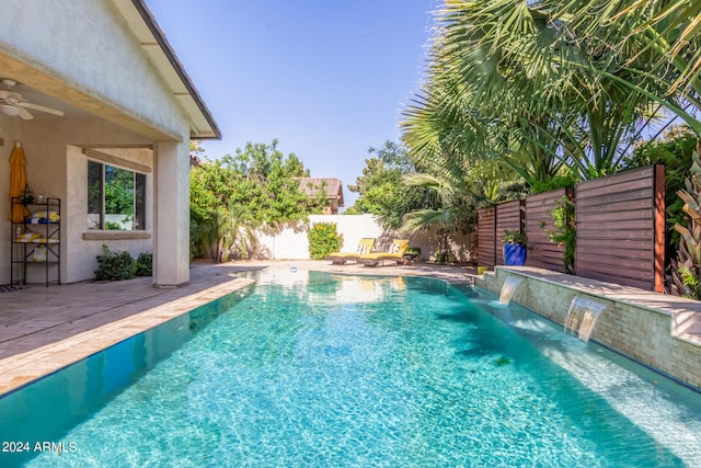 view of pool with pool water feature and ceiling fan