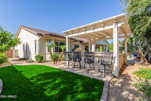 exterior space featuring outdoor dry bar and a pergola