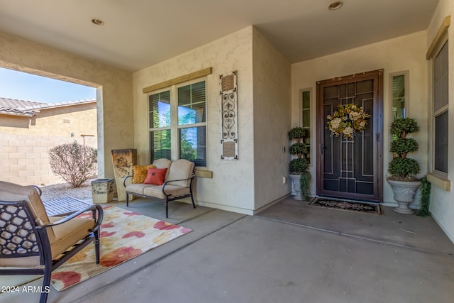 view of exterior entry featuring a patio