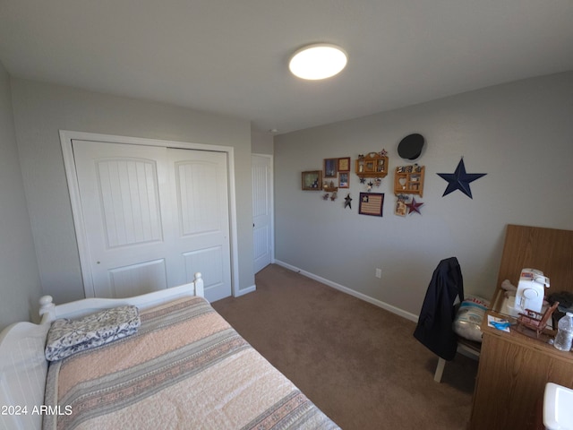 carpeted bedroom with a closet and baseboards