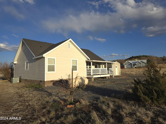 view of home's exterior with crawl space and a wooden deck