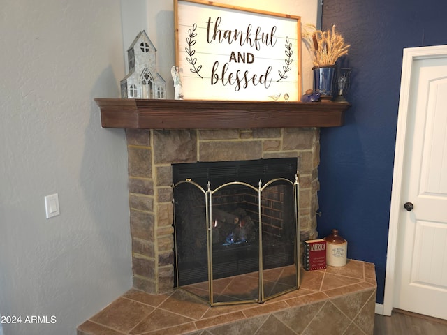 interior details with a fireplace and wood-type flooring