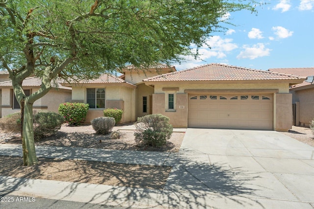 3310 W Chambers St, Phoenix, AZ 85041 - view of front facade featuring stucco siding, an attached garage, a tiled roof, and driveway
