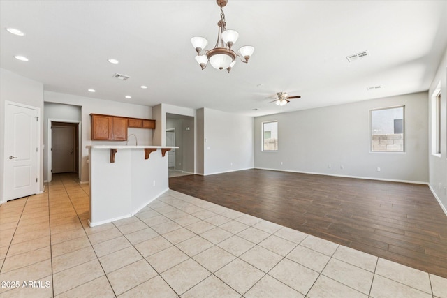 3310 W Chambers St, Phoenix, AZ 85041 - kitchen featuring ceiling fan, a chandelier, recessed lighting, open floor plan, and light wood-style flooring