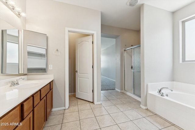 3310 W Chambers St, Phoenix, AZ 85041 - full bath featuring vanity, a stall shower, a garden tub, and tile patterned flooring