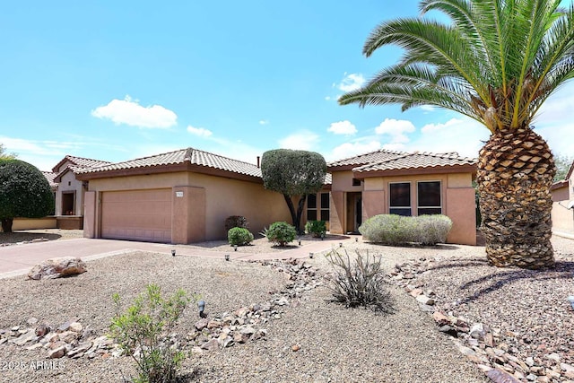 17630 N Somerset Dr, Surprise, AZ 85374 - mediterranean / spanish-style house with stucco siding, a tile roof, an attached garage, and concrete driveway