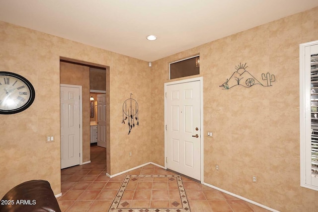 17630 N Somerset Dr, Surprise, AZ 85374 - entryway featuring baseboards, light tile patterned floors, and inlaid floor details
