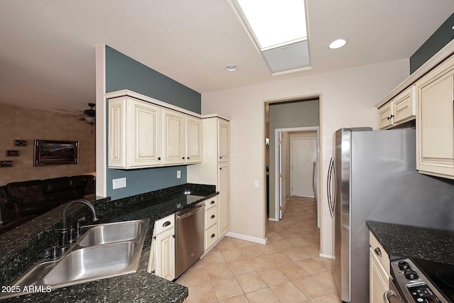 17630 N Somerset Dr, Surprise, AZ 85374 - kitchen with a sink, stainless steel appliances, light tile patterned flooring, ceiling fan, and dark stone counters