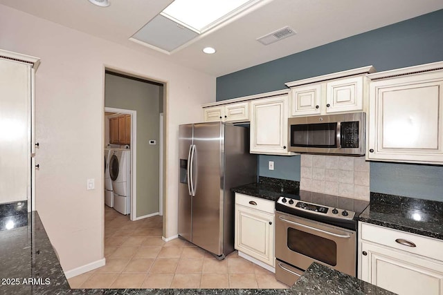 17630 N Somerset Dr, Surprise, AZ 85374 - kitchen featuring appliances with stainless steel finishes, decorative backsplash, independent washer and dryer, light tile patterned floors, and baseboards