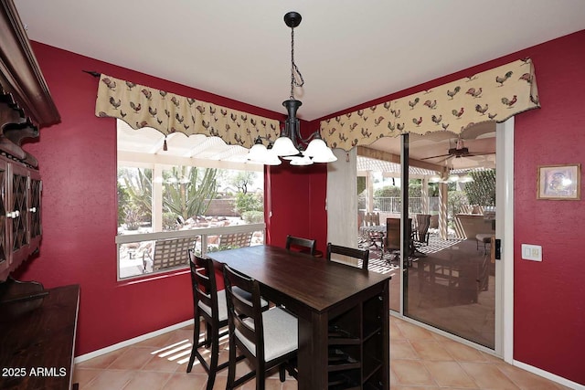 17630 N Somerset Dr, Surprise, AZ 85374 - dining area with a chandelier, light tile patterned flooring, ceiling fan, and baseboards