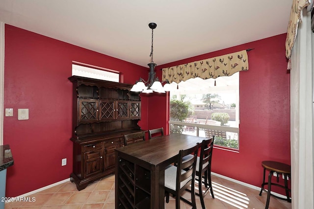 17630 N Somerset Dr, Surprise, AZ 85374 - dining space featuring a chandelier, light tile patterned floors, and baseboards